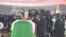 Le président ivoirien Alassane Ouattara (C) place une décoration sur le cercueil de feu le Premier ministre ivoirien Hamed Bakayoko lors de sa cérémonie d'hommage officielle le 17 mars 2021.