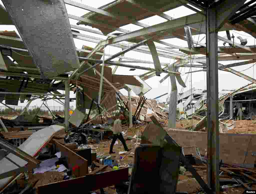 A worker checks the damages at a civilian airport under construction which, according to Iraqi religious authorities, was hit by a U.S. airstrike, in the holy Shi&#39;ite city of Kerbala, Iraq.