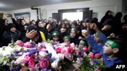 Relatives mourn Fatima Abdallah, a 10-year-old girl killed after hundreds of paging devices exploded in a deadly wave across Lebanon, during her funeral in the village of Saraain in the Bekaa valley, Sept. 18, 2024.