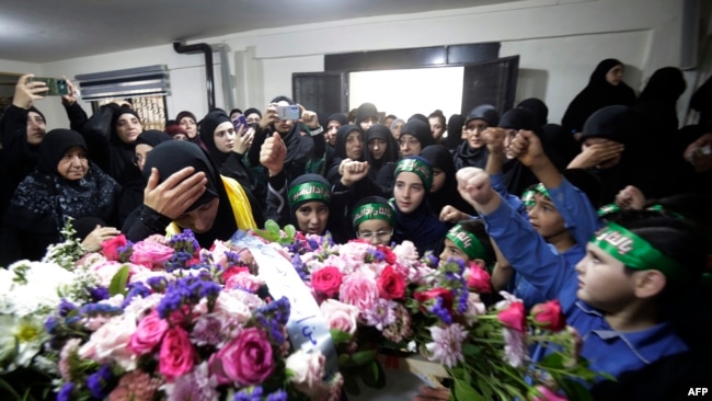 Relatives mourn Fatima Abdallah, a 10-year-old girl killed after hundreds of paging devices exploded in a deadly wave across Lebanon, during her funeral in the village of Saraain in the Bekaa valley, Sept. 18, 2024.