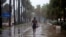 A man walks under pouring rain during Tropical Storm Isaias in Santo Domingo, Dominican Republic, on July 30, 2020. 