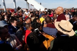 U.S. Rep. John Lewis speaks to the crowd as they cross the Edmund Pettus Bridge, in Selma, Ala., March 1, 2020.