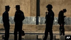 Afghan National police soldiers stand near the Defense Ministry compound in Kabul, Afghanistan, Feb. 27, 2016.