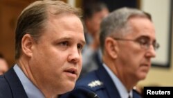 FILE - NASA Administrator Jim Bridenstine (L) makes remarks during the House Armed Services Strategic Forces Subcommittee's joint hearing with the House Science, Space and Technology Committee, in Washington, June 22, 2018.