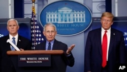 FILE - President Donald Trump and Vice President Mike Pence listen as Dr. Anthony Fauci, director of the National Institute of Allergy and Infectious Diseases, speaks about the coronavirus in the James Brady Press Briefing Room of the White House in Washi