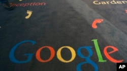 FILE - The Google logo is printed on the carpet during the inauguration of the new Google cultural institute in Paris, Dec. 10, 2013.