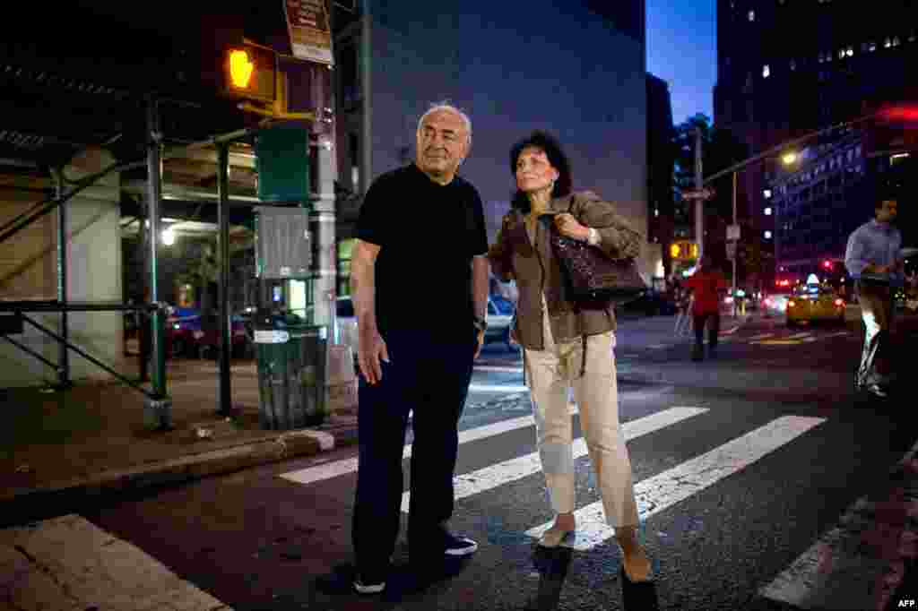 August 25: Former IMF chief Dominique Strauss-Kahn and his wife Anne Sinclair try to catch a cab in New York. A New York judge dropped all criminal sexual assault charges against Strauss-Kahn on Tuesday. REUTERS/Allison Joyce