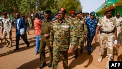 FILE - General Jamal Omar, center, a member of Sudan's Transitional Military Council (TMC), arrives in the capital Khartoum's twin city of Omdurman, July 4, 2019. 