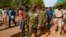 FILE - General Jamal Omar, center, a member of Sudan's Transitional Military Council (TMC), arrives in the capital Khartoum's twin city of Omdurman, July 4, 2019. 