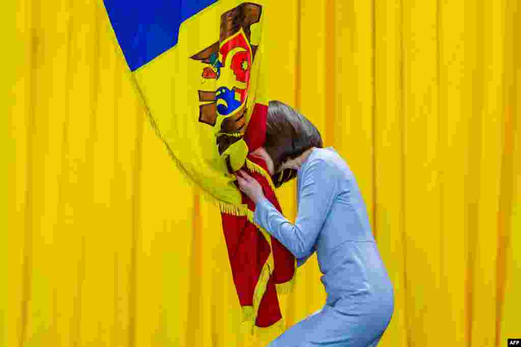 Moldova's President-elect Maia Sandu kisses the national flag during her inauguration ceremony in Chisinau.