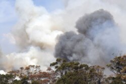 Smoke from bushfires rises in Penrose, New South Wales, Australia, Jan. 10, 2020. High temperatures and strong winds were expected to fan massive bushfires blazing across southeastern Australia and authorities issued new warnings.