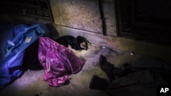 The body of a Syrian woman is seen near Izaz's Hospital after being shot by a sniper in the countryside around Izaz, near the Turkish border with Syria, October 1, 2012.