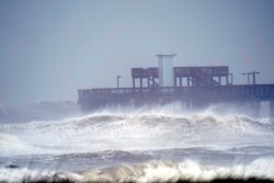Waves crash near a pier at Gulf State Park, in Gulf Shores, Ala., Sept. 15, 2020.