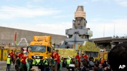 The statue of Egyptian Pharaoh Ramses II is surrounded by honour guards as it is moved to be displayed at a permanent location at the Grand Egyptian Museum (GEM) in Cairo, Egypt, Thursday, Jan. 25, 2018. 