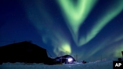 FILE - In this March 9, 2018, file photo provided by the U.S. Navy, the aurora borealis displays above Ice Camp Skate in the Beaufort Sea during Ice Exercise (ICEX) 2018. 