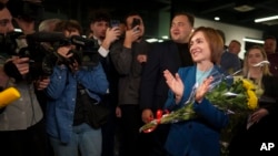 Moldova's President Maia Sandu celebrates with supporters as preliminary results are announced for the presidential election runoff in Chisinau, Moldova, Nov. 3, 2024.