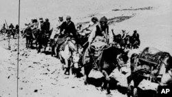 In this March 21, 1959 file photo the Dalai Lama and his escape party is shown on the fourth day of their flight to freedom as they cross the Zsagola pass, in Southern Tibet, while being pursued by Chinese military forces, after fleeing Lhasa.