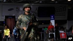 FILE - A police officer patrols inside Rio de Janeiro International Airport in Rio de Janeiro, Brazil, July 27, 2016.