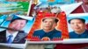 FILE - In this Feb. 5, 2015 file photo, vendors sell posters of Chinese President Xi Jinping, left, and Communist Party founder Mao Zedong, center and right, on a street of Gujiao in northern China's Shanxi province. 
