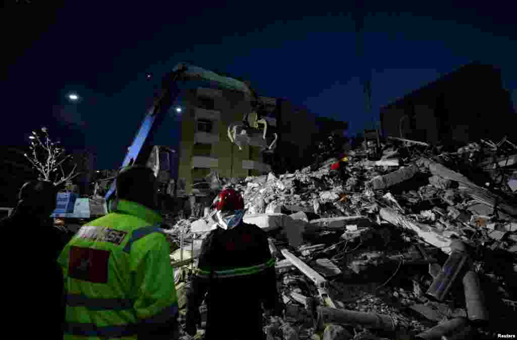 Emergency personnel work at site of collapsed building in Durres, after an earthquake shook Albania, Nov. 26, 2019. 