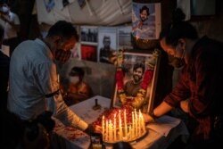 Journalists light candles and pay tribute to Reuters photographer Danish Siddiqui in New Delhi, India, July 17, 2021. The Pulitzer Prize-winning photographer was killed as he chronicled fighting between Afghan forces and the Taliban.