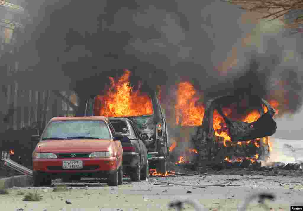 Vehicles engulfed in flames can be seen after a suicide bomber detonated a car bomb in Jalalabad, Afghanistan.