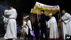 Chinese Bishop Joseph Li Shan, second from right arrives for the Christmas Eve mass at the Xishiku Catholic Church in Beijing, China, Monday, Dec. 24, 2018. (AP Photo/Ng Han Guan)