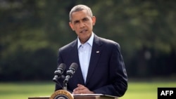 President Barack Obama speaks on the South Lawn of the White House in Washington, Saturday, Aug. 9, 2014, about ongoing situation in Iraq before his departure on Marine One for a vacation in Martha's Vineyard. 