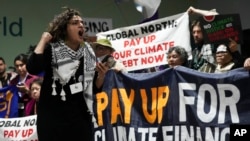 FILE - Activists participate in a demonstration for climate finance at the COP29 U.N. Climate Summit, Nov. 22, 2024, in Baku, Azerbaijan.