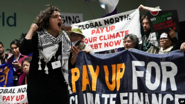 FILE - Activists participate in a demonstration for climate finance at the COP29 U.N. Climate Summit, Nov. 22, 2024, in Baku, Azerbaijan.