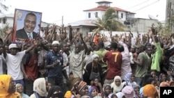 Holding a photo of their presidential candidate, supporters from the opposition CUF party gather at Bwawani, counting center for the Zanzibar Electoral Commission (ZEC), in Stonetown on the island of Zanzibar, Tanzania, 01 Nov 2010