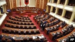 Albanian Lawmakers take part in an parliament session as the seats of the main opposition Democratic party (L) are empty, in Tirana, April 11, 2017. 