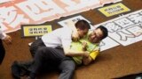 Ruling and opposition lawmakers fight each other on the legislature floor in Taipei, Taiwan. Taiwanese lawmakers exchanged punches and thrown water at each other ahead of an expected vote authorizing a referendum on whether to go ahead with the construction of a fourth power plant. 
