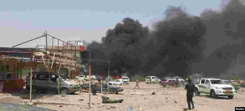 Smoke rises from the site of a car bomb attack in the town of Tuz Khormato, Iraq, June 9, 2014.