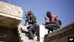 FILE - Militants from the Kurdistan Workers' Party, or PKK, run as they attack Turkish security forces in Nusaydin, Turkey, March 1, 2016. 