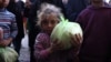 A Palestinian girl carries a bag of bread outside a bakery in Khan Younis on the southern Gaza Strip, Oct. 29, 2024, amid the ongoing war between Israel and the Palestinian militant group Hamas.