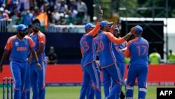 Teammates congratulate India's Rishabh Pant after he took a wicket during the ICC men's Twenty20 World Cup 2024 group A cricket match between India and Pakistan at Nassau County International Cricket Stadium in East Meadow, New York on June 9, 2024. (Pho