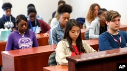 Students at Fort Lauderdale High School participate in a moment of silence during the one-year anniversary of the Marjory Stoneman Douglas High School shooting, Thursday, Feb. 14, 2019, in Fort Lauderdale, Fla.
