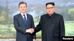 South Korean President Moon Jae-in shakes hands with North Korean leader Kim Jong Un during their summit at the truce village of Panmunjom, North Korea, May 26, 2018.