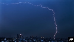 A bolt of lightning strikes during an early morning storm in Mexico City, June 22, 2020.