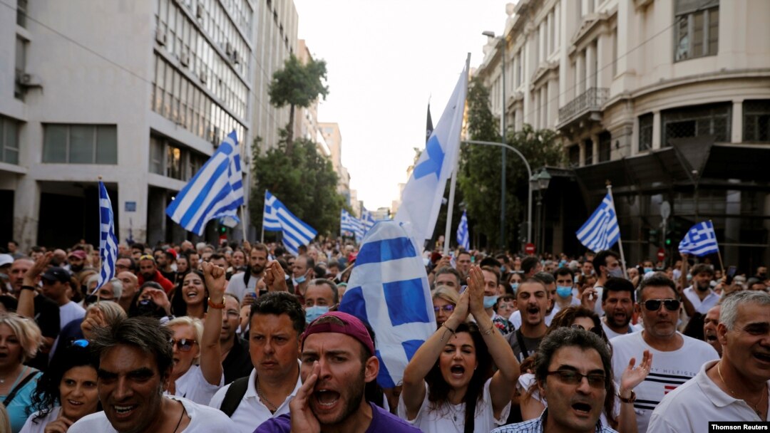 Anti-vaccine demonstrators shout slogans during a protest against coronavirus disease (COVID-19) vaccinations, in Athens, Greece, July 24, 2021.