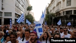 Anti-vaccine demonstrators shout slogans during a protest against coronavirus disease (COVID-19) vaccinations, in Athens, Greece, July 24, 2021.