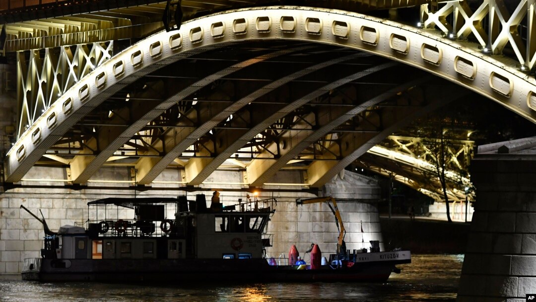 FILE - A boat taking part in the rescue operations is anchored under Margaret Bridge in Budapest, Hungary, June 5, 2019. 