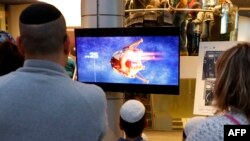 Warga menyaksikan tayangan televisi tentang rencana pendaratan pesawat ruang angkasa Israel, Beresheet, sesaat sebelum pesawat itu menabrak Bulan. Mereka menyaksikan acara tersebut di Planetaya Planetarium, di Kota Netanya, 11 April 2019.