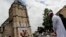 Muslim worshipers hold a minute of silence in front of a memorial at the Saint Etienne church in St. Etienne du Rouvray, Normandy, France, July 29, 2016, where Catholic priest Jacques Hamel was killed by Islamist attackers.