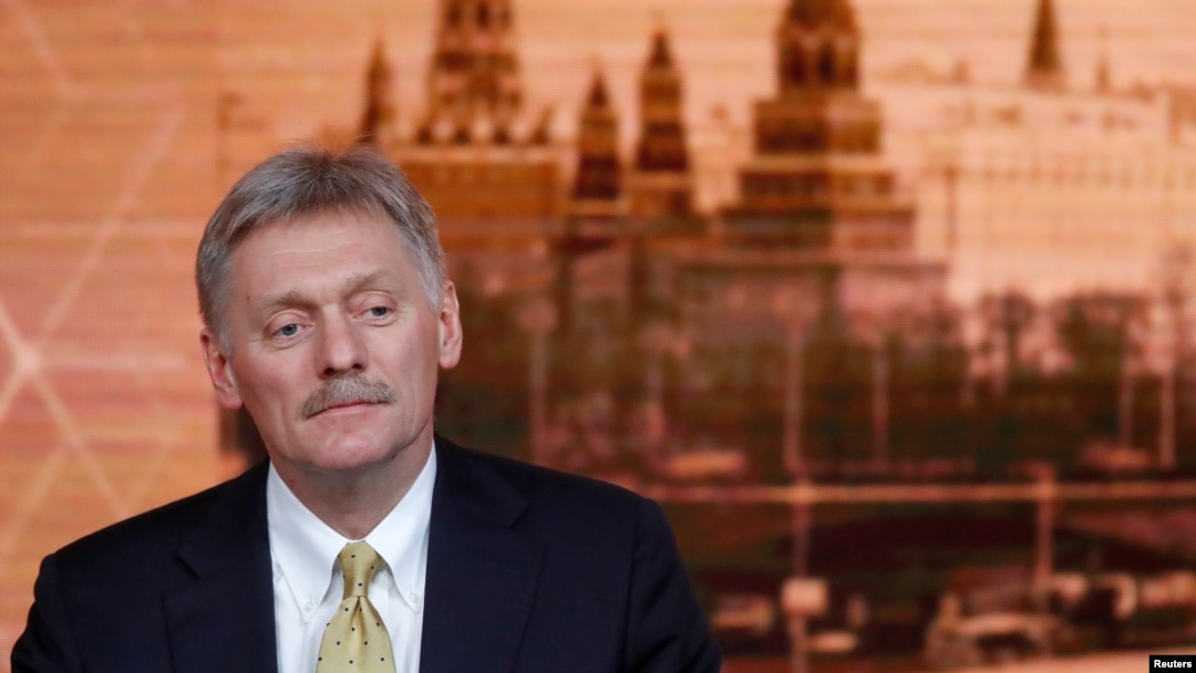 FILE - Kremlin spokesman Dmitry Peskov listens during Russian President Vladimir Putin's annual end-of-year news conference in Moscow, Russia, Dec. 19, 2019. 