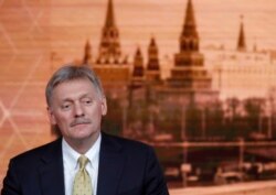 FILE - Kremlin spokesman Dmitry Peskov listens during a news conference in Moscow, Russia, Dec. 19, 2019.