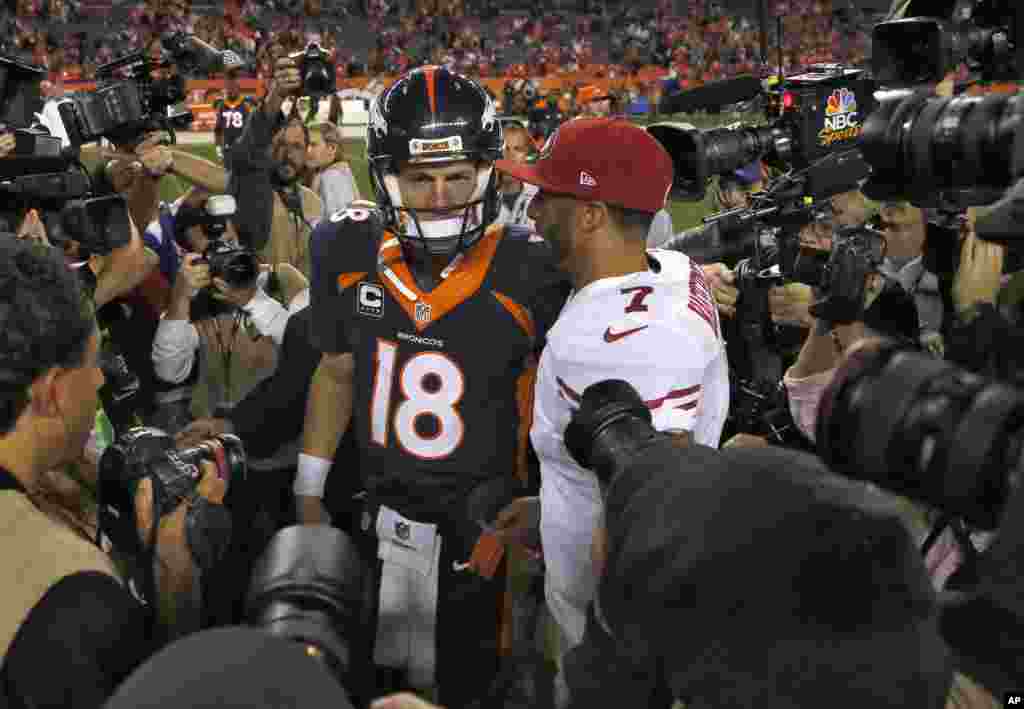 Denver Broncos quarterback Peyton Manning greets San Francisco 49ers quarterback Colin Kaepernick after the game in Devner, Oct. 19, 2014.