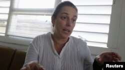 Artist Tania Bruguera, among those reportedly taken away after police broke up a Jan. 1, 2015, protest in Havana, talks to a reporter, Dec. 31, 2014.