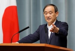 FILE - Japan's Chief Cabinet Secretary Yoshihide Suga attends a news conference at Prime Minister Shinzo Abe's official residence in Tokyo, May 29, 2017.